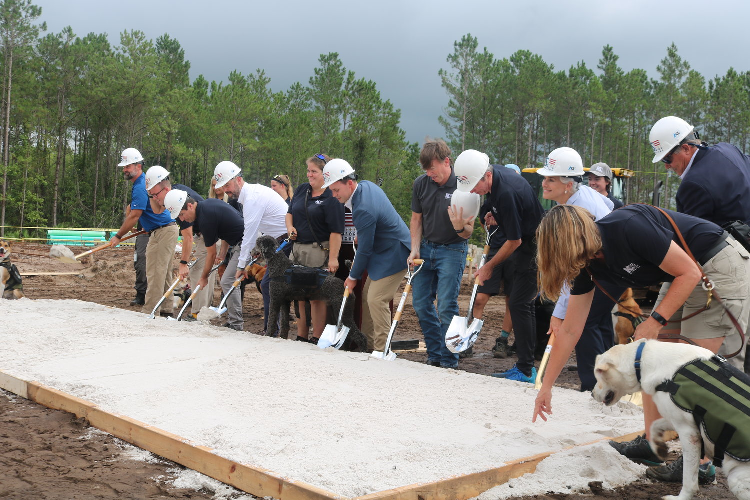 Members of the K9s For Warriors team grab their shovels and break ground on the future site of the Campus for K9 Operations during a ceremony on Aug. 4.